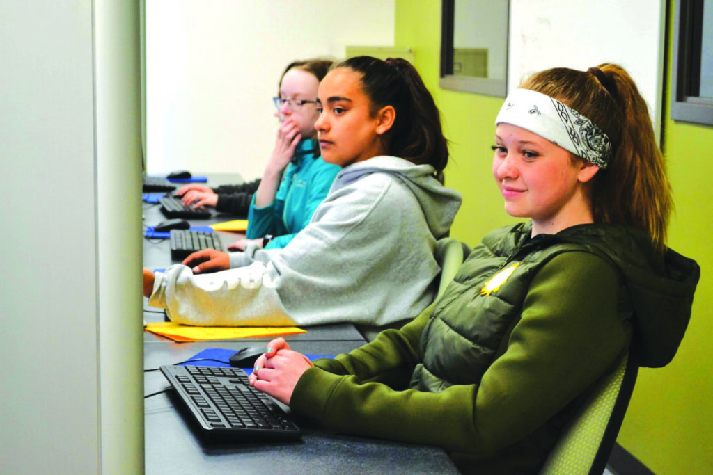 Several middle-school girls in the engineering lab at Girls Go Tech.
