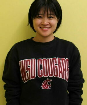 Haruka Akiyama posing in WSU Cougars gear against yellow background