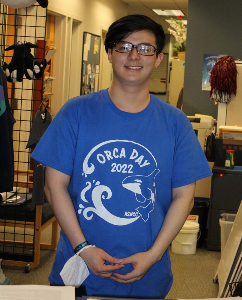 Quan Duong wearing a blue t-shirt that says "Orca Day 2022"