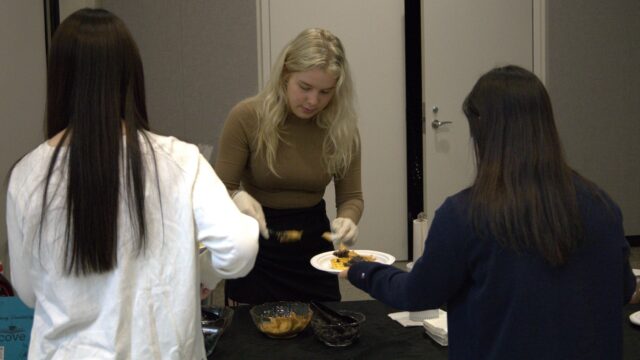 Kaitlyn Cox serves up food at a recent Wingles event.