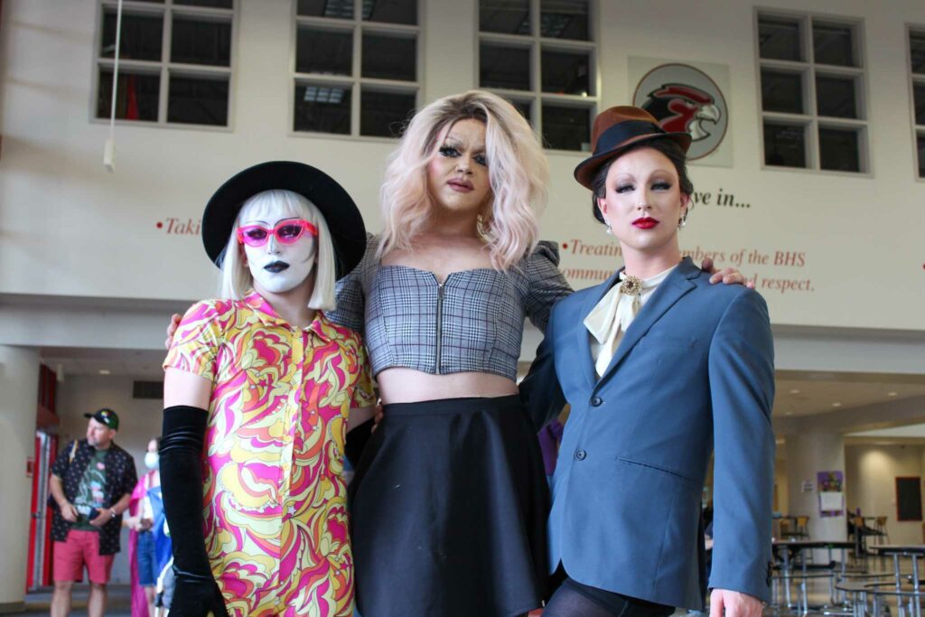 Three drag queens pose